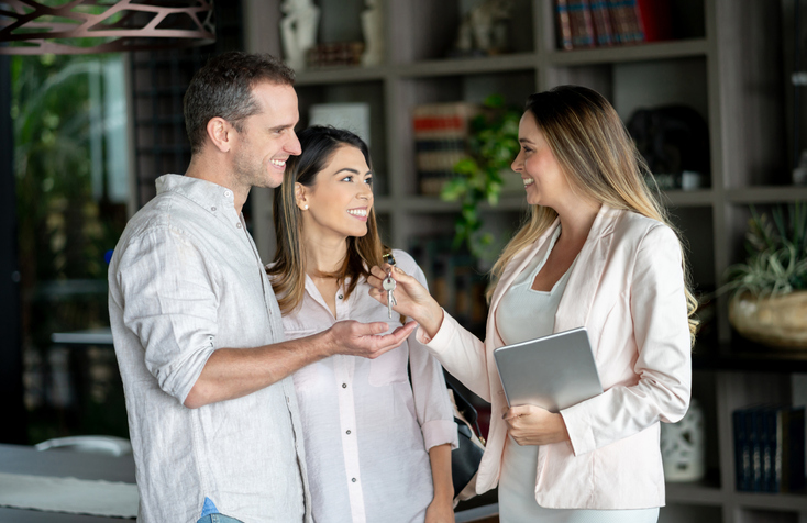 happy couple talking to their real estate agent